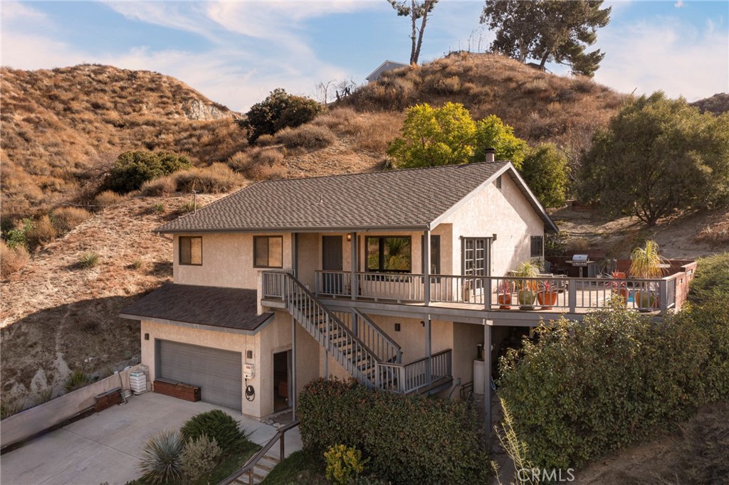 Seize the rare opportunity to own this extraordinary secluded home. Land Land Land four additional lots and a sound studio. It offers breathtaking canyon views and two sound studios/music rooms—perfect for music enthusiasts and creatives. As you enter, the first thing you'll notice is the stunning canyon vista from the living room and pool deck, creating a tranquil, resort-like atmosphere. The kitchen is equally captivating, featuring a custom mosque glass backsplash, a Viking range, and high-end stainless steel appliances, all framed by scenic hilltop views. The home offers three charming bedrooms, each with its own unique view, with the primary suite opening to a wrap-around patio that leads to a private spa, pool, and viewing deck—ideal for unwinding or entertaining. The patio is accessible from both the kitchen and living room, creating a seamless indoor-outdoor flow. Solar and charging station installed. This home has a rich history, having been owned by notable figures in the music industry. Custom hardwood and Italian porcelain tile flooring throughout. Downstairs, you'll find two separate, music rooms/studios, offering the perfect space for recording, practice, or creative collaboration. Located just 40 minutes from downtown, in the serene community of Val Verde, this property is truly one-of-a-kind. The nearby community park offers tennis courts, a basketball court, a playground, and a baseball field, as well as a shaded picnic area. Embrace the charm and tranquility of this historic neighborhood, while enjoying the ultimate in privacy, creative potential, and modern living. Don't miss out—schedule your private tour today and discover your dream home! Additional lots are 3271-016-014, 3271-016-013, 3271-016-010, 3271-016-009 No HOA no Mello Roos. Country living that is city close!