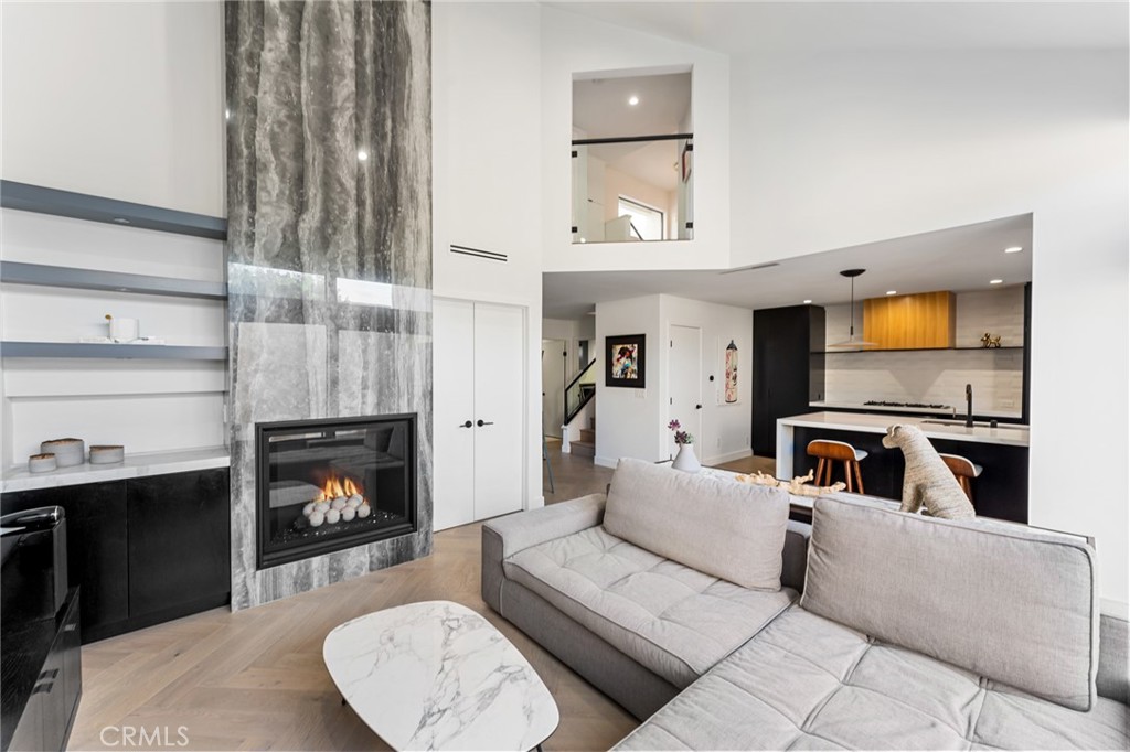 Fully Remodeled Rancho San Joaquin Modern Townhome allows you to step into unparalleled sophistication with this meticulously remodeled 3-bedroom, 2.5-bathroom townhome, completed in 2022. With bespoke modern architectural design and luxury finishes, this home redefines contemporary living.
The heart of the home features designer kitchen complete with custom millwork of hand selected oak veneer cabinetry, large panoramic porcelain-covered island with stunning waterfall edges, a convenient breakfast counter, and appliances from Fisher Paykel and Bertazzoni. This space seamlessly flows into the great room, adorned with a massive gas fireplace encased in slab porcelain.
Enjoy the expansive living with a great room, which opens to a large private outdoor courtyard – perfect for entertaining or relaxing in privacy. The herringbone wood flooring extends throughout the main level, enhancing the modern aesthetic. A versatile guest bedroom or office features sliding glass doors that open to a private front courtyard.
The upper level boasts a custom glass and metal staircase leading to an incredible master suite and a third bedroom, each with its own private bath. The master bath is a true gem, featuring floor-to-ceiling slab porcelain walls, a standalone tub, real walnut vanities, and walk-in shower with rainhead and shower wand. The upstairs guest bath also includes a walk-in shower with a floor-to-ceiling tile surround.
Luxury touches abound throughout the home, including a level 5 drywall finish, light and bright ambiance, built in shelving with undermount led lighting, coffee bar, cabinet pull outs, designer chandelier in stairwell, thoughtfully designed quartz ledges on all windowsills, and electric blinds. For your furry companions, the laundry area includes a large DOG WASH station!
This is one of the rare units in the complex offers direct access to a fully finished two-car garage, complete with floor coating, a 220V outlet for electric vehicles and built-in shelves. New A/C unit placed in January 2025!
Furnishings negotiable at close of escrow.
The craftsmanship of this remodel was masterfully completed by One Contracting and Remodeling LLC with custom millwork cabinetry by CabinetsOC.