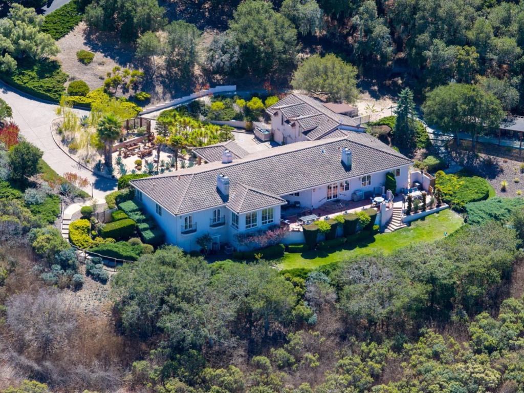 Perched atop one of Bay Ridges premier ocean-view parcels, this Mediterranean-inspired estate captures sweeping vistas of the Monterey Bay, Pasadera Country Club, city lights, and rolling hills. Set on over three private acres, the home offers both serenity and sophistication in a coveted gated community. A graceful portico entry sets the tone for the interiors, where 10-foot ceilings, custom arched French doors, and expansive windows flood the home with natural light while framing unforgettable views. The residence includes 4 bedrooms, 4.5 baths, with a guest quarter above the three-car garage. The gourmet kitchen opens seamlessly to a sunny terrace, ideal for indoor-outdoor living and entertaining. The beautifully landscaped grounds feature mature trees and multiple patio spaces, thoughtfully designed for quiet reflection or gathering with friends. Exceptional craftsmanship and timeless design define this home, making it a rare opportunity to experience the very best of California coastal living.
