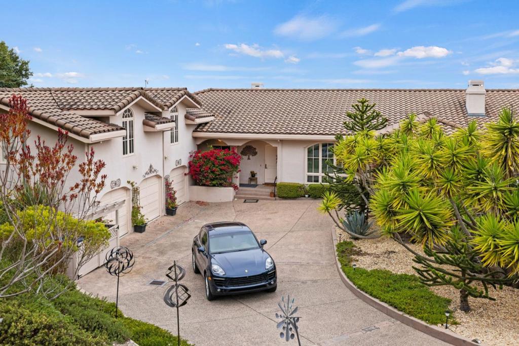 Perched atop one of Bay Ridges premier ocean-view parcels, this Mediterranean-inspired estate captures sweeping vistas of the Monterey Bay, Pasadera Country Club, city lights, and rolling hills. Set on over three private acres, the home offers both serenity and sophistication in a coveted gated community. A graceful portico entry sets the tone for the interiors, where 10-foot ceilings, custom arched French doors, and expansive windows flood the home with natural light while framing unforgettable views. The residence includes 4 bedrooms, 4.5 baths, with a guest quarter above the three-car garage. The gourmet kitchen opens seamlessly to a sunny terrace, ideal for indoor-outdoor living and entertaining. The beautifully landscaped grounds feature mature trees and multiple patio spaces, thoughtfully designed for quiet reflection or gathering with friends. Exceptional craftsmanship and timeless design define this home, making it a rare opportunity to experience the very best of California coastal living.