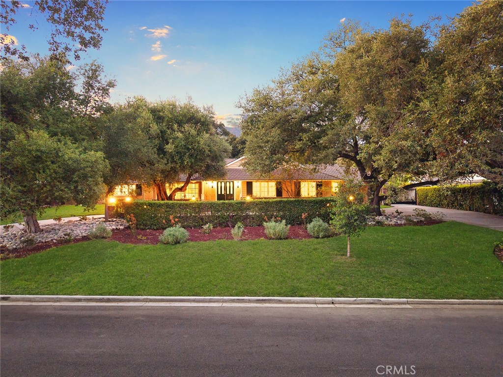 Welcome to 935 Fallen Leaf Road—nestled on a serene, tree-lined street in one of Arcadia’s most prestigious neighborhoods. This beautifully remodeled single-story estate sits on a sprawling 42,486 sq.ft. lot and features 5 spacious bedrooms and 5.5 bathrooms across 4,006 sq.ft. of elegant living space. The home offers a perfect blend of classic architecture and modern luxury, featuring vaulted wood-beamed ceilings, hardwood floors, and multiple fireplaces throughout. The formal living and dining rooms are perfect for entertaining, while the expansive family room boasts custom built-ins and seamless access to the outdoors. A chef’s dream kitchen anchors the home with custom cabinetry, quartz countertops, premium stainless-steel appliances, and an oversized island. The adjacent breakfast area is surrounded by large windows overlooking the tranquil backyard. The professionally landscaped grounds are a true oasis, complete with a putting green, mature oak trees, and multiple patios ideal for gatherings or peaceful reflection. Enjoy privacy, space, and timeless charm—just minutes from award-winning Arcadia schools, shops, and dining. Don’t miss this rare opportunity to own a legacy property in the heart of Arcadia.