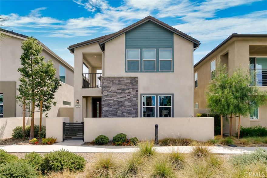Welcome 116 Zawn, this stunning 2022-built 2,311 sq. ft. detached home, perfectly situated in the highly sought-after Solis Park neighborhood within Irvine’s prestigious Great Park community. Featuring the community’s most popular floor plan, this south-facing residence is filled with abundant natural light and showcases a seamless open-concept design, ideal for modern living. The first floor boasts a spacious layout highlighted by a gourmet kitchen with white cabinetry, thick quartz countertops, stainless steel appliances, and a built-in refrigerator. Ample storage can be found both inside the home and in the garage. Upstairs, the luxurious owner’s suite offers a spa-like bathroom, while the standard loft provides a versatile space perfect for a home office or children’s play area. This exceptional home is located just steps from Solis Park’s “The Retreat” — a resort-style amenity featuring a sparkling pool, spa, outdoor gathering spaces, high-end BBQ stations, and elegant fire pits. Directly facing Solis Park K–8 School and only a five-minute walk to Portola High School, this location offers unmatched convenience for families. *Designer-selected furnishings and décor are available for purchase with the home. Buyers may acquire the full collection or select individual pieces, with pricing determined by the items chosen. Experience the best of Great Park living in this beautifully appointed home — a true must-see!