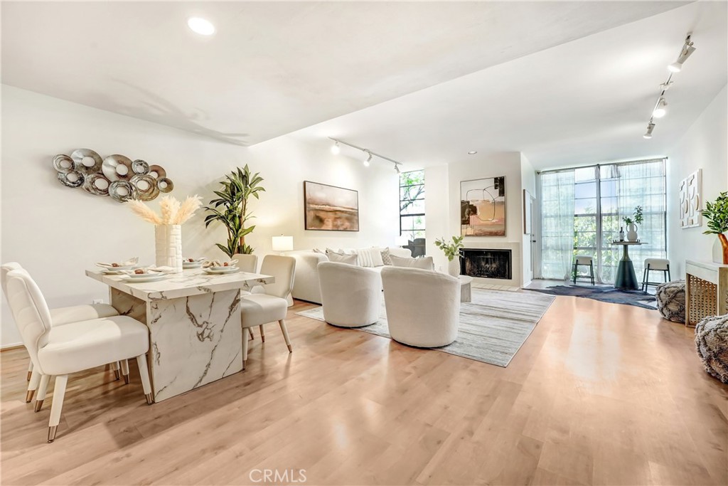 Move-in ready 2BR/3BA modern condo in the iconic Skyline Townhomes, designed by Lorenzo Tedesco. This stylish two-story unit features an open floor plan with a spacious living room, fireplace, private balcony, powder room, and updated kitchen. Upstairs includes a primary suite with views, large closet, en-suite bath, a second bedroom, full bath, in-unit laundry, and outdoor seating area. 1,429 sq ft with two side-by-side parking spots. Gated mid-century modern complex with pool and spa. Prime Hollywood Hills location with easy access to the 101, Hollywood, Studio City, shops, and restaurants.