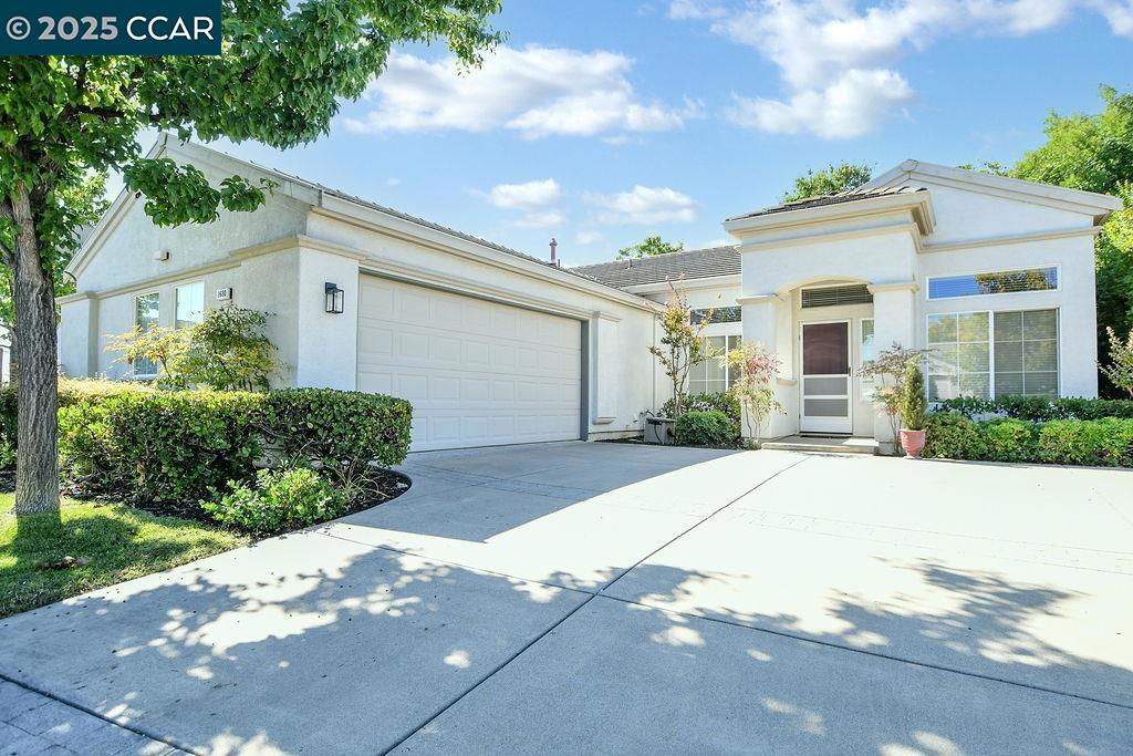 Welcome to this charming 55+ Summerset 1 residence, where comfort meets convenience in a low-maintenance setting. Situated on a desirable corner lot, the home invites you in with a charming covered entrance. Inside, you're greeted by high ceilings that flood the space with natural light, creating a warm and inviting atmosphere. The open-concept layout is perfect for both relaxation and entertaining, featuring two spacious living areas, a cozy fireplace, and a formal dining area. The eat-in kitchen is a chef's delight, complete with a breakfast bar and freshly painted cabinets. Both spacious bedrooms offer the luxury of walk-in closets, while the primary bathroom is equipped with double sinks for added convenience. Additional highlights of this home include an indoor laundry room with a sink and storage cabinets, as well as a secure, attached two-car garage. Step outside to enjoy a low-maintenance yard and patio, perfect for unwinding or hosting gatherings. This lovely gated community offers a community pool/spa, gym, tennis courts, bocce ball courts, and various activity clubs. Close to John Muir, Kaiser, CVS, and Safeway. Don't miss your chance to own this lovely home and lifestyle.