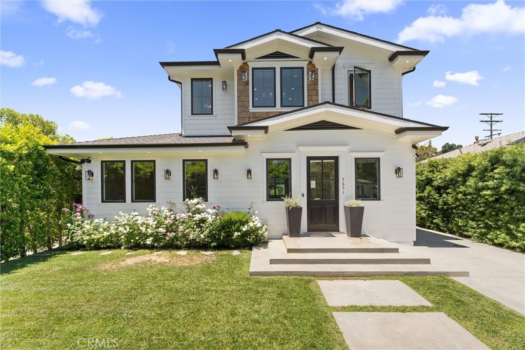 Welcome to this luxurious newer construction modern farmhouse, perfectly situated just a stone’s throw away from LA’s trendiest restaurants, coffee shops and retail destinations - including NoHo West and The Shops at Sportsmen’s Lodge. This thoughtfully designed property features a stunning main home with 4 bedrooms and 3 bathrooms. Detached is a fully equipped ADU with it's own private address, a beautiful kitchen with stainless steel appliances, living/sleeping area and modern bathroom, ideal for guests, rental income, a home office and more. As you enter the main house, you're greeted by a gorgeous fireplace that anchors the spacious open concept living, dining and kitchen areas - ideal for entertaining and modern living. The chef’s kitchen boasts sleek stainless steel appliances, a large center island/breakfast bar and an expansive view of the sparkling new pool and spa. The dining room flows seamlessly to the lush, private backyard - fully hedged with ficus trees and featuring multiple patio areas for relaxing or entertaining under the California sun. Downstairs, you’ll find two stylish bedrooms and a full bath, while upstairs hosts two more ensuite bedrooms, including a show-stopping primary suite. This tranquil retreat features vaulted ceilings, designer light fixtures, a custom walk-in closet and a spa-inspired bathroom. Step out onto the oversized private balcony and take in the serene views of the yard and pool below. Located in a prime LA location and in the Chandler school district, this exceptional property puts you close to everything - boutique shopping, top dining spots and entertainment hubs - making it the perfect place to call home.