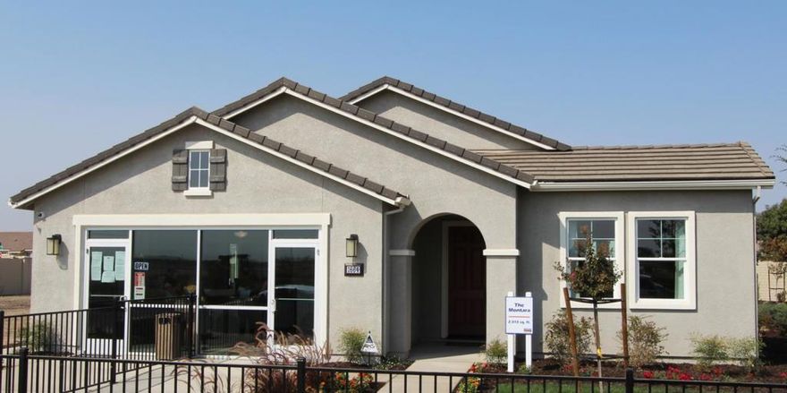 This showcase model home on a large lot is packed with over $95,000 in designer upgrades and modern finishes. Gather in the inviting great room, complete with a fireplace featuring a raised hearth, stone surround, and a wood mantel. The gourmet kitchen is a dream with quartz countertops, upgraded stainless steel Kohler sink, custom pendant lighting, under-cabinet lighting, and a complete laundry package with sink and engineered marble countertop. Elegant Sedona cabinetry throughout while brushed nickel interior plumbing, fixtures, and hardware provide a refined, timeless touch. Bathrooms feature undermount sinks and engineered marble surfaces in the primary shower enclosure, tub surround, vanities, and guest baths, accented with a custom primary bathroom backsplash. Upgraded flooring throughout enhances every living space, while thoughtful upgrades like a ceiling-mounted kitchen speaker, whole house fan, tankless gas water heater, and a pre-wired alarm system add convenience. Outdoor living is easy with a fully landscaped and irrigated front and backyard, concrete patio areas off the dining slider and back of the home, and a textured, painted garage- garage will be converted prior to move in.