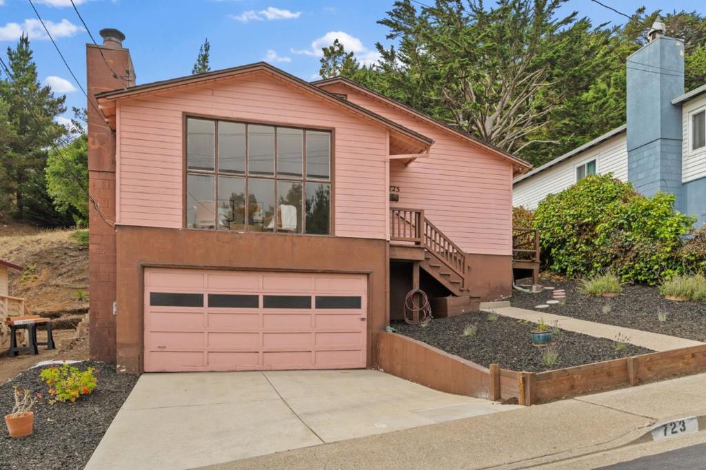 Nestled in East Sharp Park, this 3 bed / 1.5 bath home combines classic charm with laid-back coastal living. Step into a bright, spacious living room with floor-to-ceiling windows showcasing stunning mountain views and a cozy wood-burning fireplace. A formal dining area flows into the kitchen, creating a functional layout ideal for both everyday living and entertaining. The primary bedroom features an ensuite half bath and opens directly to a generous 7,500+ sq ft lot, offering endless potential for outdoor living, gardening, or future expansion. Located just minutes from the beach, Pacifica Pier, golf, and local shops, plus quick access to Highway 1 and I-280, making commuting into San Francisco or down the Peninsula convenient. With some TLC and your personal touch, this home is ready to become truly your own.