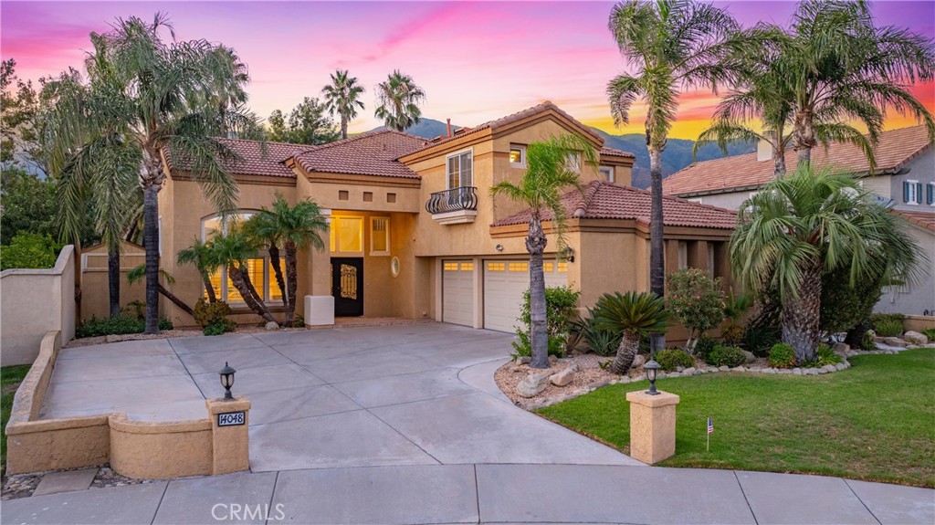Stunning 5-bedroom, 3-bathroom home in Brentwood Estates, perfectly blending comfort and style. Located on a quiet cul-de-sac in the award-winning Etiwanda School District, this residence showcases soaring vaulted ceilings, laminate wood flooring, a custom media center with fireplace, and a unique refrigerated wine cellar. The remodeled chef’s kitchen features upgraded cabinetry, quartz countertops, waterfall island, stainless steel appliances, farmhouse sink, and elegant gold finishes. One bed and bath are conveniently located on the main level. Upstairs, all bedrooms feature recently upgraded flooring and wood shutters, while the spacious primary suite offers a sitting area, mountain views, walk-in closet, and a fully upgraded bathroom with newer soaking tub, shower, dual sinks, and cabinets. The backyard is resort-style with a waterfall, in-ground spa, covered patio, golf putting green, storage shed, and lush palm trees. The 3-car garage offers ample space and includes a water leak detection system for peace of mind. This is a rare opportunity to own a beautifully upgraded home in the highly sought-after Brentwood Estates community!