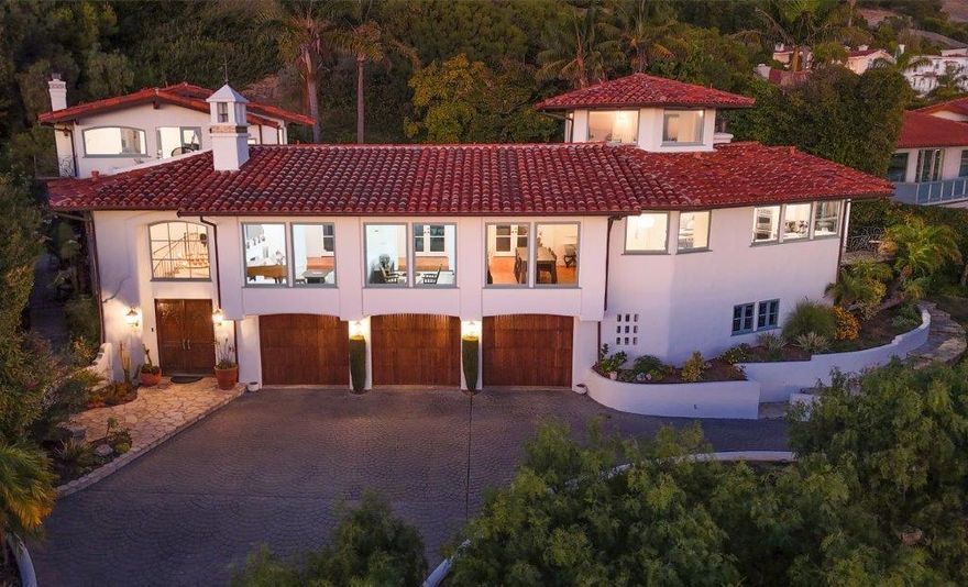 A rare coastal estate of timeless Spanish elegance, this exceptional residence commands sweeping panoramic views of the Pacific Ocean, Catalina Island, dramatic coastline, and an iconic championship golf course. Ideally situated in prestigious Rancho Palos Verdes, this 5-bedroom, 4.5-bath home offers approximately 4,960 square feet of refined living space on a generous 14,211-square-foot lot, moments from scenic oceanfront trails.A grand entry and architectural staircase set an immediate tone of sophistication, leading into sun-drenched interiors defined by soaring ceilings, expansive picture windows, and exquisite craftsmanship throughout. The formal living and dining rooms, along with the kitchen and breakfast area, are perfectly oriented to capture breathtaking ocean vistas, creating an extraordinary backdrop for daily living and elegant entertaining.At the heart of the home, the chef's kitchen is both striking and functional, featuring a large porcelain-topped island, Sub-Zero refrigeration, Viking six-burner range with double ovens, and seamless flow into the family room with fireplace and custom library nook. French doors open to an inviting indoor-outdoor terrace, ideal for hosting or quiet moments overlooking the sea.The primary suite is a private sanctuary, accessed via its own staircase and offering multiple balconies and a terrace with commanding views of the cliffs and coastline. Dual walk-in closets and a spa-inspired bath with soaking tub, dual vanities, and an oversized walk-in shower complete this luxurious retreat. Three additional bedrooms are thoughtfully placed on the main level, while a versatile lower-level bonus suite with separate entrance and full bath offers flexibility for guests, a gym, or media lounge.Crowning the home is a distinctive tower room--an inspired space for an office, studio, or entertaining with panoramic coastline views. The secluded backyard provides a tranquil, landscaped oasis, complemented by an oversized three-car garage, wine cellar, and private basketball court. An exceptional offering combining architectural presence, scale, privacy, and breathtaking coastal views--this is California luxury living at its finest.