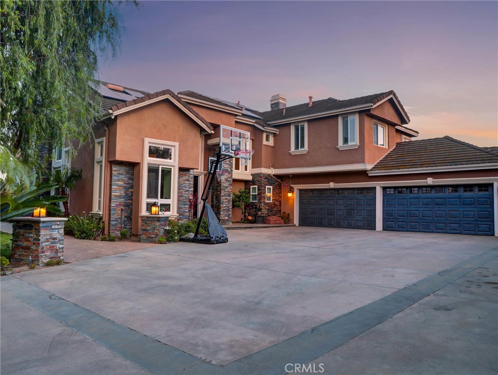 Breathtaking panoramic views estate located on an cul-de-sac street!! This extraordinary home offers forever unobstructed views of stunning city lights and mountains! Tesla Solar system, 40 Panasonic 330 watt panels paid off. 4 Tesla power wall battery system paid off. 5 bedrooms/4.5 bathrooms and 4 car garage, super long driveway. Enter through the double doors into this stunning interior filled with natural light and 20ft ceilings. The remodeled gourmet kitchen boasts an enormous island, custom cabinetry, breakfast bar, dual dishwashers, three ovens, newly Wolf Range, Sub-zero refrigerator, gorgeous views from the kitchen, stainless steel appliances, granite counter tops and much more. Whole house soft water system, Indoor and out door Sonos speaker systems. Downstairs bedroom with a bathroom, office/den area, formal living room with fireplace, separate family room with fireplace, wet bar, powder room and individual laundry room. Tile flooring throughout the downstairs. The beautiful wrought iron stair case leads upstairs to a huge master bedroom with double door entry, marble fireplace, large master bathroom with 2 big walk in closets and large balcony with incredible views, large bonus room/games room and two other bedrooms and bathroom. Enjoy this incredibly elegant resort-like backyard with covered patio. breathtaking sweeping mountain views and city lights views. Large Trampoline, basketball hoop, Pool, spa, waterfalls all remodeled with pavers, child protection fence, an absolute entertainers delight. Totally separate guest house with upgraded kitchen, living room, fireplace, laundry room, soft water system and individual HVAC system, bedroom with incredible views and own patio!! Its like a 2nd house on your property. Some of the best schools in North County include Yorba Linda High School. Welcome your forever dream home!