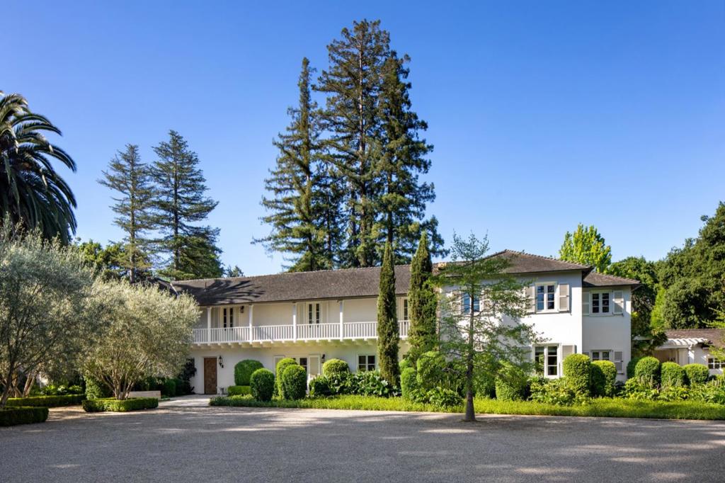 In Atherton's most prestigious Menlo Circus Club area, this classic estate, originally built in 1935, has been meticulously transformed into an exquisite retreat, elegant yet completely livable. Reimagined by a team of leading design professionals to offer the best of California living, this Monterey Colonial is perfectly proportioned, with exceptional craftsmanship and stunning design. Experience timeless sophistication in every room with tastefully selected wall coverings, luxury marble and tile finishes, and carefully curated light fixtures that set just the right mood. Arranged on two levels with a separate guest house, this home offers every amenity desired today, including ample space for work from home, distance learning and indoor/outdoor entertainment. Ideally situated on one acre of land, the estate offers complete privacy in a resort-like garden setting. The impressive array of outdoor features includes a wisteria covered loggia, a landscape framed fire-pit terrace, pool and spa, two water features, and beautifully cultivated grounds with heritage olive trees. This extraordinary property, located midway between San Francisco and Silicon Valley, presents a rare opportunity to enjoy the quintessential California lifestyle on one of Atherton's most coveted avenues.