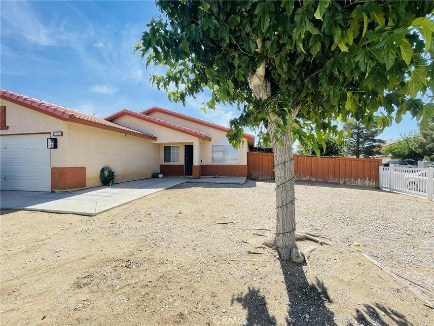 Corner home located in New Adelanto! This house features 4bedrooms 2bathrooms and fully fenced front and back yards. As soon as you enter you are welcomed by a spacious living area. To the left is a hallway that leads to the bedrooms, hallway bathroom, and laundry room. At the end of the hallway, to the right, is the primary bedroom with its private bathroom and a walk-in closet. The living area and dining area are separate spaces. The dining area has a gas fireplace, perfect for gathering. The u-shaped kitchen with a breakfast bar is right across from the dining area. Across from the kitchen is the door to the backyard. The backyard has a desert landscape easy to maintain and an attached patio pergola. In addition, this home has updated AC, furnace, and 3yr old water heater. At the side of the home, is a shade sitting on concrete for RV or open to your imagination.