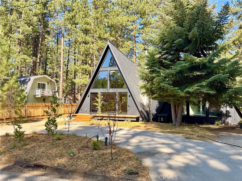 Welcome to your idyllic A-frame retreat in Big Bear, perfectly located near Snow Summit and the pristine shores of Big Bear Lake. This stunning home captures the essence of mountain living with its unique architecture and inviting ambiance. Step inside to indulge in the pinnacle of luxury living, featuring exquisite watermarked fixtures, top-of-the-line luxury appliances, and striking black slate flagstone flooring that adds an artistic touch. Large windows flood the space with natural light, creating a cozy living area ideal for relaxation after a day of adventure. The well-appointed kitchen is equipped with modern appliances and generous counter space, perfect for whipping up meals to share with loved ones. Outside, enjoy three expansive decks crafted from premium redwood, offering spectacular mountain views—ideal for soaking in the sun or stargazing at night. With easy access to skiing, hiking, and lake activities, this A-frame home is not just a residence; it’s your gateway to a lifestyle filled with outdoor fun and serenity. Seize the opportunity to own this beautiful retreat in Big Bear!