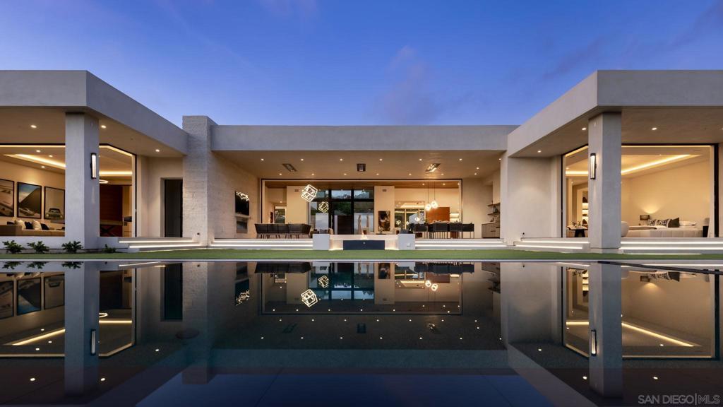 Brand-New Construction 2024 offers grand scale living with elegant proportions on 3.35-acres with unparalleled design and located on the sought after west side of RSF Covenant! Scale & Style to a level for impeccable living and amazing year-round indoor-outdoor luxury. 5-star resort-like living showcasing approx. 8,900+SF of ideal One-Level living, clean lines and grand spaces with 5 ensuite bedrooms, 6 car garage and full Detached 1-Bdrm Guest House overlooking scenic VIEWS tucked behind private gates on one of the most coveted streets in Rancho Santa Fe Covenant! An architectural triumph estate (on Solar) including zero-edge infinity pool w/ full pool bathroom, formal dining and home office both looking out to beautiful courtyard infinity pond, wine cellar, state-of-the-art systems including motorized lift doors, Control4 Smart House technology, detailed security system, custom lighting and multiple outdoor lounging areas including a sunken firepit that all provide for easy and luxe open-air enjoyment. The open chef's kitchen is built with Wolf appliances, oversized island, high-end cabinetry and wet bar. A secondary back kitchen is designed for ease of catering/prep. The primary suite with a fireplace features stunning views overlooking the pool, Views, His/her closets, large shower and stunning stone soaking tub. An incredible one-of-a-kind oasis with complete privacy and comfort, this sophisticated estate presents a truly elevated lifestyle experience.
