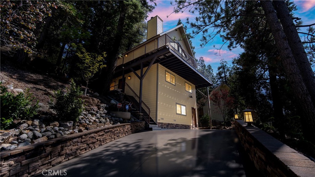 Modern Mountain Retreat with Lake Rights + Dock in Lake Arrowhead’s Coveted North Bay.
Located in the exclusive Arrowhead Woods community—with full lake rights—this fully furnished A-frame mountain retreat blends contemporary comfort with timeless alpine design. Featuring 3 bedrooms, 3 bathrooms, and a bonus loft, the home offers soaring ceilings, a spacious open-concept living area, and a custom floor-to-ceiling stone fireplace. The kitchen is appointed with quartz countertops and stainless steel appliances, while a whole-home sound system and smart thermostat add a touch of modern luxury.
Enjoy sweeping woodland and mountain views from the newer Trex wraparound deck, or host under the stars on the rear terrace, complete with custom lighting, a built-in fire pit, and a jacuzzi pad.
Also available for purchase is the seller’s ½ double dock with dock cover—nestled in the deep, calm waters of Lake Arrowhead’s highly sought-after North Bay. Dock N-482 Slip A. MLS# CV25164424
Whether you're entertaining guests, investing in a vacation rental, or seeking a private year-round escape, this turnkey home delivers on every front—just minutes from Grass Valley Park, Lake Arrowhead Village, and the country club.