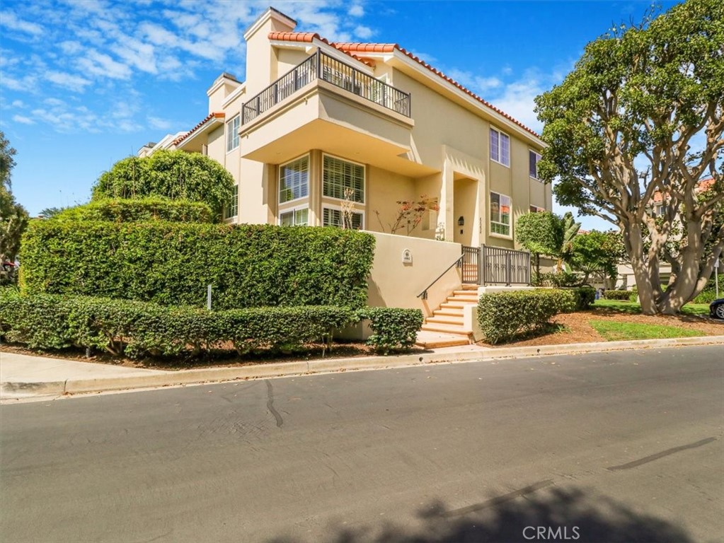 Nestled in a peaceful interior end-unit location within the prestigious ocean-close, guard-gated community of SeaCliff on the Greens, this stunning townhome offers coastal living just steps from the sandy shores of Huntington Beach. Boasting 2,236 square feet of refined living space, the home features 3 spacious bedrooms and 2.5 well-appointed bathrooms. Step through the expansive wraparound front patio into a bright and inviting living room with soaring vaulted ceilings, a cozy stone fireplace, and dramatic floor-to-ceiling windows accented with custom shutters. The open-concept dining area flows effortlessly into a beautifully designed kitchen, complete with a breakfast bar, sunny nook, and an adjoining family room ideal for everyday living and entertaining. Upstairs, the luxurious primary suite impresses with high ceilings, a private balcony with ocean views, and a spa-inspired en-suite bathroom featuring dual sinks, a vanity area, soaking tub, and a walk-in shower. Two additional upstairs bedrooms share a tastefully updated full bathroom with a stylish walk-in shower. Enjoy the outdoors on the beautifully landscaped private patio, featuring elegant brick hardscaping and direct access from the great room through dual sliding doors. Perfect for entertaining guests. Located just moments from the community pool and spa, a ton of guest parking and this home features a full-length driveway. Steps to scenic parks, nature trails, the wetlands, award-winning schools, and the iconic Dog Beach, this home offers the best of Southern California living in one of Huntington Beach’s most sought-after communities.