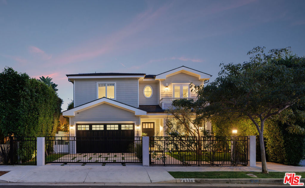 Tucked away in the highly coveted Beverly Grove neighborhood, this Cape Cod-inspired residence blends timeless design with modern luxury, creating the ideal setting for elevated family living. The entry level welcomes you with a grand two-story foyer and a thoughtfully designed floor plan featuring formal living and dining rooms, a versatile en suite bedroom or home office, and an expansive great room that flows seamlessly into the kitchen. The chef's kitchen is a standout, equipped with a Bertazzoni Heritage 6-burner range with griddle, custom cabinetry, and elegant quartzite countertops that elevate both form and function. Beautiful oak floors flow effortlessly throughout the home, leading to folding glass doors that open to a private outdoor retreat. This tranquil sanctuary includes a covered patio with a new ceiling fan, a dedicated dining area, lush new turf and landscaping, and a sparkling pool and spa complete with a rebuilt pump enclosure and added child safety fencing - perfect for both entertaining and everyday enjoyment. Upstairs, the primary suite is a private retreat, featuring an expansive terrace, dual custom closets, and a newly reimagined spa-inspired bath with a soaking tub, custom vanity, plaster accents, updated lighting and mirrors, and a Toto bidet. Upstairs you'll find three additional en suite bedrooms - two with views of the iconic Hollywood Sign - along with a fully customized new laundry room with upgraded tile and cabinetry. Every detail has been thoughtfully enhanced, from retrofit LED lighting and whole-home screens and blinds to upgraded audio, video, and security systems - including DoorBird entry, 24/7 recording, and seamless smart app integration. The finished garage includes new cabinetry, decorative lighting, a workbench, Tesla-ready 240V charger, and a brand-new door and motor. Additional highlights include new private front and side gates with stucco privacy walls, a generator connection at the main panel, multi-zone climate control, and fully paid solar providing energy efficiency and long-term savings. Securely gated and just moments from LA's premier dining, shopping, and entertainment, this move-in-ready home combines classic elegance, contemporary convenience, and the warmth of true family living.