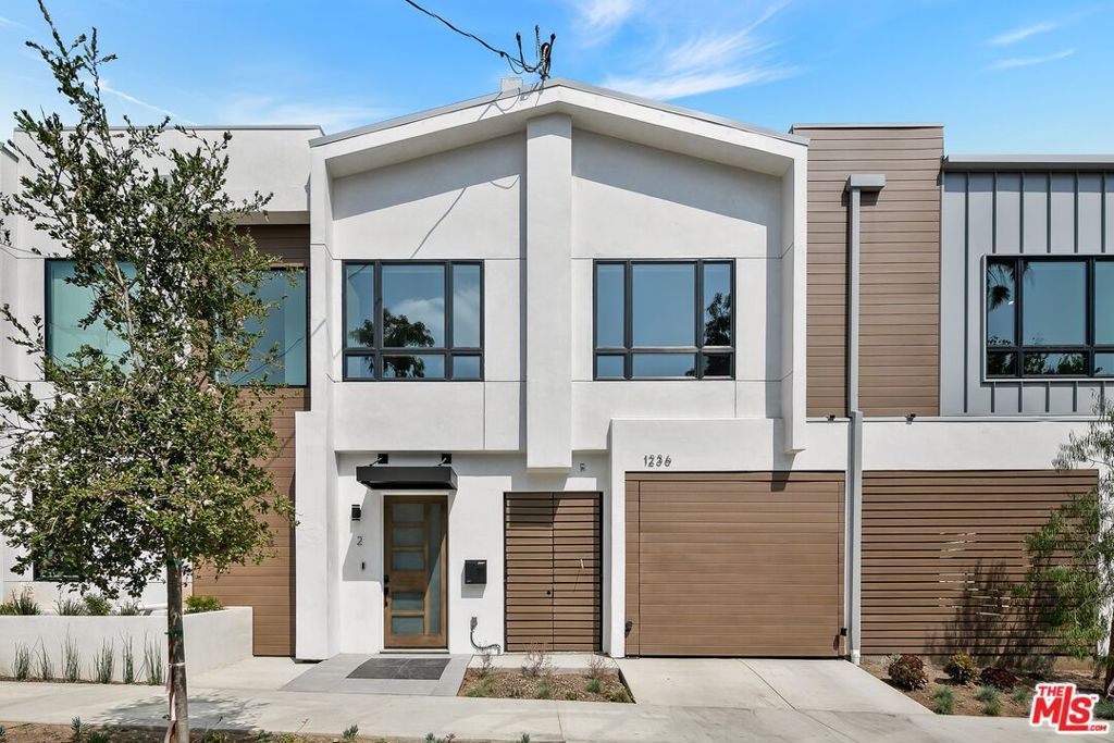 Enjoy a newly-constructed and modern townhouse in a central West Hollywood location. Walk through the front door and head up the stairs to the living space. Relax on the couch and put your drink down on the coffee table all watch your favorite streaming services and local channels on the flat-screened Smart TV. Cook a meal in the large kitchen with brand-new stainless-steel Thermidor appliances. Enjoy your food at the gorgeous kitchen island with bar stool seating for 4, or gather in the dining area with a dining table and seating for 6. Down the hallway you will find the Master suite with a King bed, spacious walk-in closet, Smart TV, and private balcony with lounge furniture. The attached Master bathroom offers dual sinks and a shower. To the right of the kitchen, you will find the second bedroom with a King bed, sliding closet doors, and attached bathroom with a sink and standing shower. Both bedrooms offer room-darkening shades to provide the best comfort and sleep possible. Head up an additional flight of stairs for shared rooftop access and the best Hollywood views. The unit offers garage parking for 2 vehicles and a washer and dryer. Recessed lighting and hardwood flooring through the home. Price above is for a one year furnished lease.