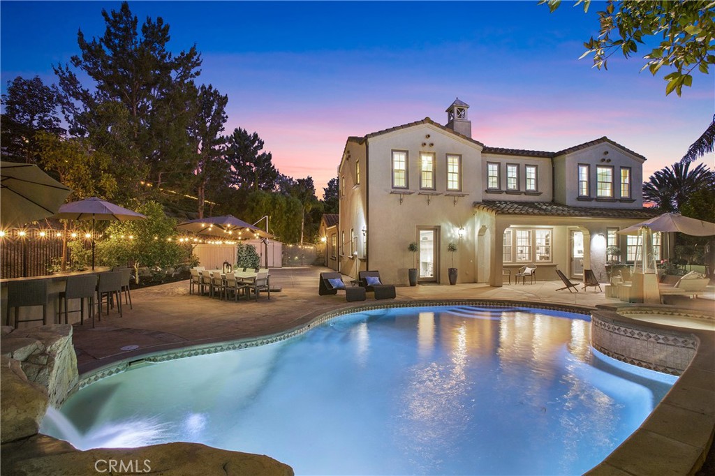 Rare End-of-Cul-de-Sac Estate with Expansive Wraparound Grounds and Resort-Style Amenities. Nestled at the end of a private cul-de-sac within the prestigious guard-gated community of Covenant Hills, 1 Lennox represents an extraordinary opportunity to own one of the largest and most coveted lots in the neighborhood. Spanning 16,685 sq. ft., this rare wraparound estate delivers a seamless blend of privacy, luxury, and functionality across its resort-style outdoor spaces and beautifully updated interiors. An extended private driveway—accommodating up to 10 vehicles—leads to an entertainer’s dream backyard oasis. The grounds boast a saltwater pool and spa accented by dual rock waterfalls, a built-in BBQ island, and ample room for a basketball half-court. A large, gated lawn shaded by fruit trees creates an idyllic space for children, pets, or elegant garden parties. An enchanting central courtyard features a fireplace, bistro lighting, and a serene fountain, ideal for al fresco dining or evening relaxation under the stars.
Spacious and thoughtfully designed interiors offering approximately 4,600 sq. ft. of refined living space, the home features 5 bedrooms, a dedicated office, retreat, and 5.5 bathrooms. At the heart of the home is the chef’s island kitchen, outfitted with top-tier Viking appliances, double ovens, Dacor refrigerator, quartz countertops, custom tile backsplash, soft-close cabinetry with pull-outs and a spice rack, as well as a butler’s pantry and coffee station. French doors open to a breeze-filled patio—perfect for hosting gatherings or daily enjoyment.
Additional highlights include a wine and beverage room with a large serving island, dual wine fridges, and guest seating. A main floor guest suite with an adjacent bathroom adds convenience and flexibility. The expansive laundry/utility room includes dual washers and dryers, three custom workstations, and ample open shelving. Upstairs, the primary suite offers a private balcony overlooking the courtyard, a spa-inspired bathroom with soaking tub, separate shower, dual vanities, walk-in closet, and a custom retreat. Three additional bedrooms—two with en-suite bathrooms—offer versatile spaces for family, guests, or creative use. Enjoy 24-hour guard-gated security, high-speed internet, and access to premium community amenities including clubhouses, swimming pools, scenic trails, lush parks, and sports courts.