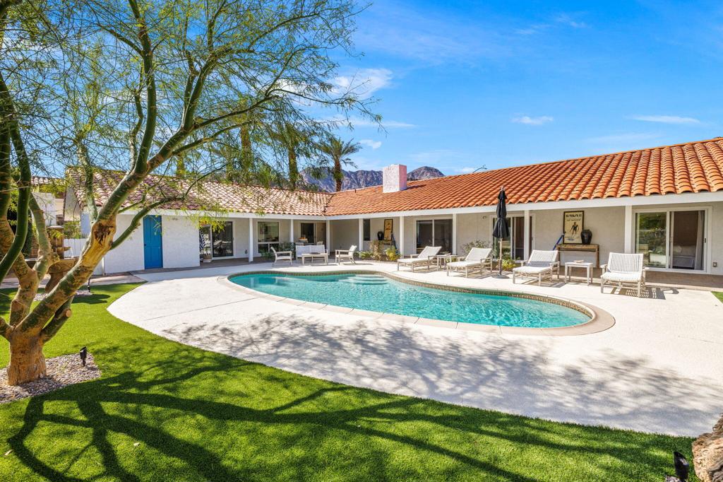Nestled within the prestigious La Quinta Golf Estates, this exceptional home seamlessly blends timeless Spanish-style architecture with sleek modern updates. The expansive living room boasts soaring vaulted ceilings and a striking fireplace, framing breathtaking views of the private backyard oasis. The open-concept design effortlessly flows from the fully renovated kitchen to the dining and family rooms, creating a space perfect for both relaxation and entertaining. The luxurious primary suite is thoughtfully positioned in its own secluded wing, offering unparalleled privacy. Step outside to your own serene resort-style retreat, where sweeping mountain views surround a spacious backyard with a covered patio and plenty of room for entertaining guests. Ideally located near the renowned La Quinta Resort, world-class shopping, and top-tier championship golf courses, this home presents the ultimate in comfort, style, and convenience.