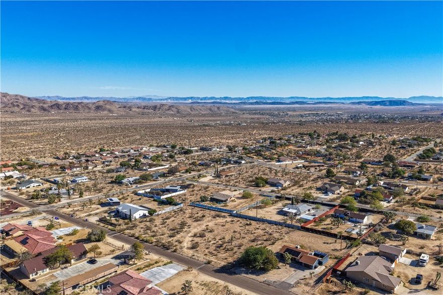 Expansive 26,075 square foot parcel located in the highly desirable Lower Friendly Hills neighborhood of Joshua Tree. This spacious lot offers beautiful mountain and desert views, providing the perfect setting to build your dream home, vacation retreat, or investment property. Utilities are believed to be available at the street—buyer to verify.
Just minutes from downtown Joshua Tree and the entrance to Joshua Tree National Park, this location offers convenient access to local cafés, art galleries, and live music venues. Enjoy the best of Hi-Desert living with nearby attractions such as the Joshua Tree Music Festival, weekly Farmers Market, and endless outdoor adventures beneath stunning desert skies.