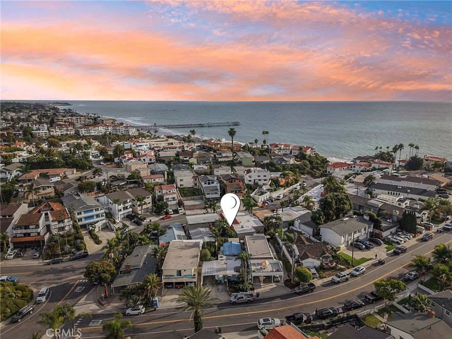 Welcome to 229 West Canada, a charming beach cottage nestled in the heart of San Clemente’s iconic Spanish Village by the Sea. Just steps from the sand, this delightful home captures the essence of coastal living — where you can hear the waves crash, watch whales spout offshore, breathe in the salty air, and feel the ocean breeze on your skin.

Enjoy a peek-a-boo ocean view from your living room window and unwind in your private garden oasis, filled with a wide variety of fruit-bearing trees and plants — including boysenberry bushes, navel orange, fig, avocado, mango, key lime, plum, peach, apple, papaya, lemon, almond, and banana. It’s a rare coastal sanctuary for garden lovers and home chefs alike.

Zoned R2 Medium, this property offers valuable flexibility and potential — whether you're considering adding a second unit, building an ADU, or exploring future development opportunities (buyer to verify with the city).

With multiple beach access points nearby, you’re never far from the water, and the coastal beach trail, world-famous surf breaks, and the historic San Clemente Pier are all within walking distance.

This sought-after location offers the perfect blend of laid-back surf culture and vibrant community charm. Stroll to downtown San Clemente for dining, shopping, or local events, all while surrounded by nationally registered historic Spanish architecture and the timeless ambiance that makes this seaside town so special.

Whether you're seeking a vacation retreat, investment property, or your forever coastal home, 229 West Canada invites you to live the beach lifestyle you’ve always dreamed of — with fresh fruit from your own backyard to sweeten the deal.