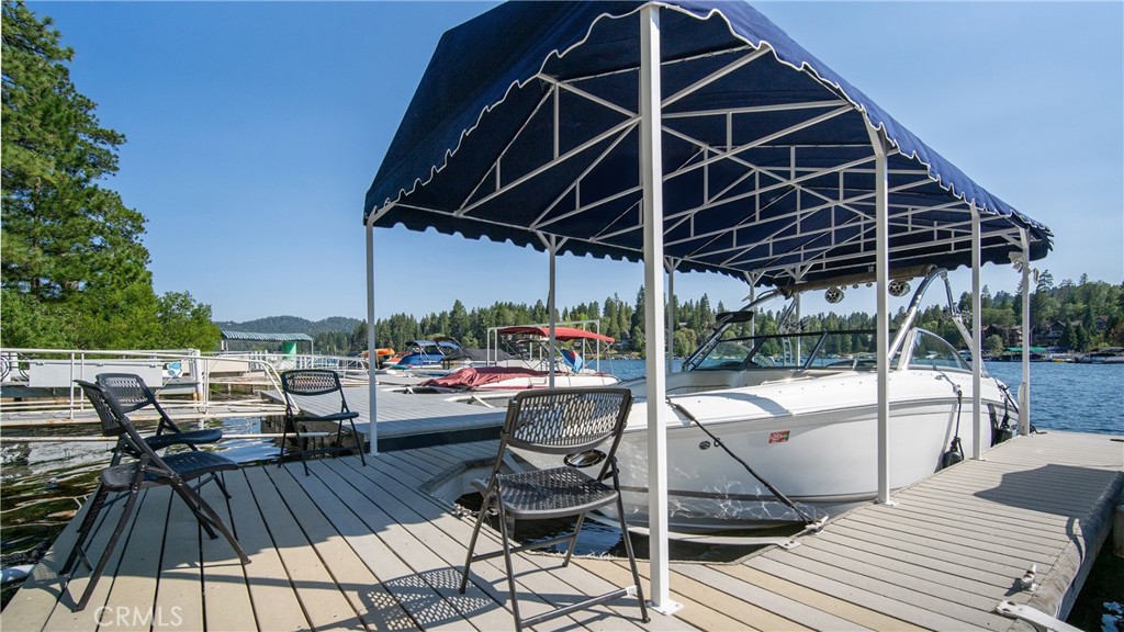 Set in the tranquil, deep waters of Lake Arrowhead’s coveted North Bay, this ½ double dock offers the ultimate lakefront experience, where calm mornings, sun-drenched afternoons, and serene evenings are all part of daily life. Thoughtfully designed for both convenience and security, the dock features a custom dock cover, a spacious gated entry, and a generously sized storage locker to house water toys, gear, or seasonal essentials. The controlled access restrooms are just steps away. Whether you’re boating, paddleboarding, or simply soaking in the silence between the pines, this private dock provides a front-row seat to Lake Arrowhead’s most exclusive lifestyle. The buyer of 26947 Tunnel Drive, MLS# CV25163216 will have the right of first refusal.