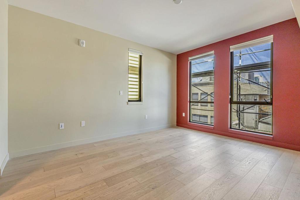 With a sleek interior, impressive shared amenities, and a central SoMa location, this 1-bedroom, 1-bath condo offers a balanced lifestyle of comfort and convenience. From the rooftop terrace with firepit seating to the light-filled living area indoors, every space feels designed with your daily rhythm in mind. Wide-plank floors and soft natural light create a welcoming ambiance as you enter the open-concept living and dining area. A full wall of windows frames city views, while the layout maintains a cozy feel that's perfect for lounging or hosting friends. Just beyond, the streamlined kitchen features flat-panel cabinetry, a gas cooktop, a built-in oven, and glossy finishes that reflect the ambient glow. Ample counter space makes meal prep easy, and theres plenty of storage to keep your essentials tucked away. Your bedroom is quietly nestled at the rear of the unit, complete with a walk-in closet and direct access to the modern bathroom. A deep soaking tub, large mirrored vanity, and tiled walls offer a clean, calming space to start or end the day. Step outside to enjoy the buildings rooftop deck with panoramic views, an outdoor kitchen, a firepit, and multiple lounge areas. You're within walking distance of cafes, groceries, and downtown transit. One pet is welcome, too.