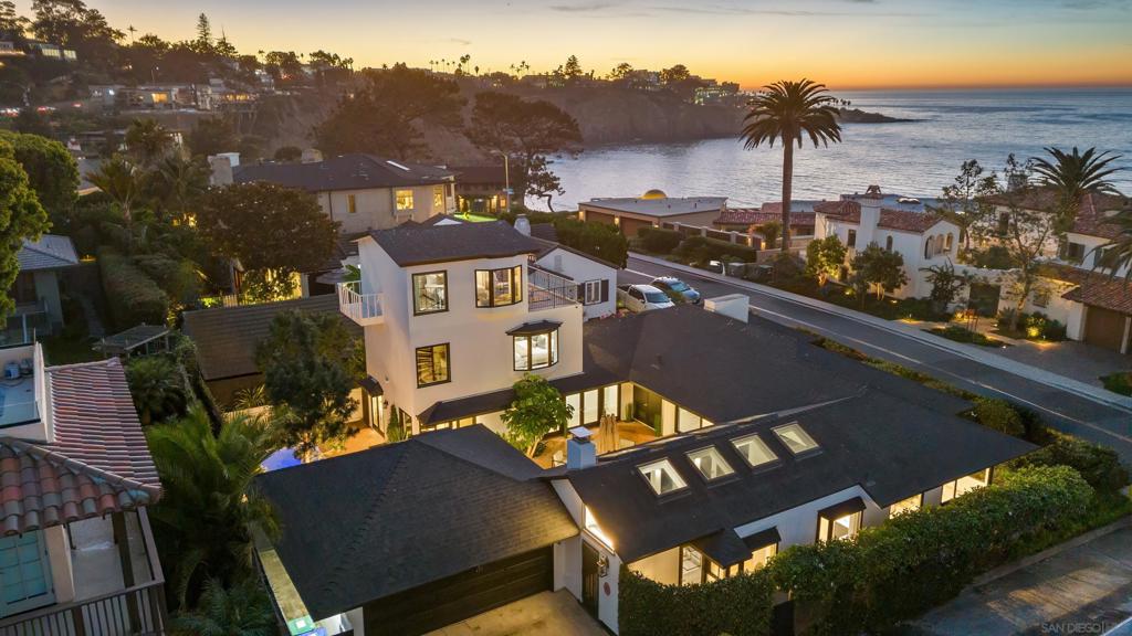 Incomparable Location - Across the street from the ocean in La Jolla Shores, just steps from the beach, dining, resorts, and shops! This spectacular 4-bedroom, 4.5-bathroom home has been completely remodeled from head to toe in November 2024 and features brand-new, top-of-the-line furnishings throughout. Each spacious bedroom boasts its own private en-suite bathroom, offering ultimate comfort and privacy for guests. This stunning home with a classic coastal vibe is perfectly situated for exploring one of La Jolla’s most sought-after neighborhoods. Enjoy breathtaking white-water views from nearly every room, as well as a brand-new, top-of-the-line jacuzzi for relaxing after a day in the sun. The elevated front patio welcomes you with an outdoor table and chairs, ideal for sunset sips while enjoying the ocean views. Inside, the open floor plan is flooded with natural light from expansive windows. The living room features ample seating, a cozy fireplace, a flat-screen TV, and sliding glass doors that open to the front patio, creating a seamless indoor-outdoor living experience. The adjacent dining room accommodates up to eight guests at its elegant table, perfect for shared meals. See supplement! The kitchen, bathed in natural light from multiple skylights, is a chef’s dream. A double island with barstool seating, stainless steel appliances, and a fireplace add to its charm, while a wall of French doors leads to a central courtyard designed for entertaining. A side patio with a conveniently located BBQ completes the outdoor spaces. Upstairs, the primary suite is accessed via a spiral staircase and offers breathtaking views. This luxurious retreat features a plush king bed, a large private balcony with seating, and an en suite bathroom. The second bedroom is spacious and includes a king bed, flat-screen TV, en suite bathroom with a dual vanity and glass-enclosed shower, and a walk-in closet. The third bedroom offers a king bed and stunning ocean views, while the fourth bedroom provides two full beds. Additional amenities include a laundry room with a washer and dryer, a two-car garage, and additional driveway parking. With its unbeatable location, modern updates, and thoughtful amenities, this home is the perfect La Jolla getaway for relaxation or adventure. SLEEPING ACCOMMODATIONS (Maximum Occupancy: 8 Guests) Bedroom 1 - 1 King bed Bedroom 2 - 1 King bed Bedroom 3 - 2 Queen beds Bedroom 4 - 1 King plus sofa couch STR-10823L TOT 658345