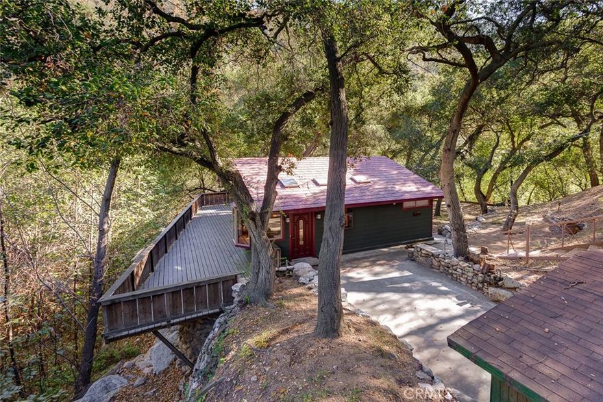 Rare opportunity to own one of the beautiful cabins nestled in the private and rustic Millard Canyon of the Angeles National Forest. The property has been lovingly renovated, ensuring that the amenities and comforts of this timeless treasure can be enjoyed for years to come. This property survived the Eaton Canyon fire. Situated under a canopy of California Oaks above a rambling stream & surrounded by hiking trails, the drive-up cabin features a open floor plan with double doors that open to a deck. The open space is positioned around the original river rock fireplace and a chef's kitchen with granite counters, stainless steel appliances, custom cabinetry and farm sink. Additional amenities include a full bath with Jacuzzi tub, a half bath, 1 bedroom, a sleeping loft, a detached storage space, tankless water heater, bonus room/closet and more. Some restrictions apply due to the recent fires and US Forestry efforts to clean up and provide safety to the area. Use of the land is authorized by a Special Use Permit. An annual use permit fee paid yearly to the US Forest Service. $300/year also paid to HOA applied towards water testing. Buyer to verify all terms and conditions and is recommended to consult with an attorney familiar with USDA Special Use Permits. Cash transaction only. May not be used as a primary residence. Under government rules, this property cannot be used for any commercial purpose, including AirB&B rentals. It does, however, offer a unique opportunity to enjoy nature and the great outdoors while building long-term family and friendship memories.