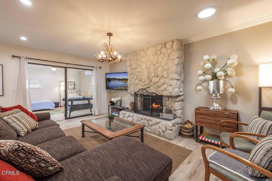 This newly remodeled, fully furnished property features 2 bedrooms plus a den (which can be used as a third bedroom) and 2 bathrooms in the main house, along with a private 1-bedroom, 1-bathroom Accessory Dwelling Unit (ADU) with its own entrance. It's perfect for larger households, multi-generational living, or anyone needing flexible space for guests, extended family, or a dedicated home office.The main house features newer flooring and elegant tile upgrades throughout. A bright, open concept layout seamlessly connects the kitchen, dining, and living areas, creating a warm and inviting atmosphere. The modern L-shaped kitchen is equipped with a large island, newer appliances, a 200-amp electrical panel, updated wiring, and newer piping, making it ideal for both everyday living and entertaining. A cozy fireplace serves as the focal point of the living room, while the dining area opens to a spacious fenced backyard with a deck, perfect for outdoor gatherings.The primary bedroom features an en-suite bathroom. The den, located off the living area, is versatile and works well as an office, guest room, or playroom, and includes its own split A/C and heating unit. Additional highlights include a separate laundry room, updated heating system, and newer water heater. The ADU offers complete privacy with a separate entrance and its own split A/C and heating unit. It includes a bedroom, bathroom, living room, and kitchen. It is ideal for extended family, guests, or other permitted uses.The large fenced backyard with a deck is perfect for entertaining, and ample on-site parking provides a major advantage in Big Bear, where overnight street parking is restricted. The home is also just minutes from The Village, the lake, and local trails.