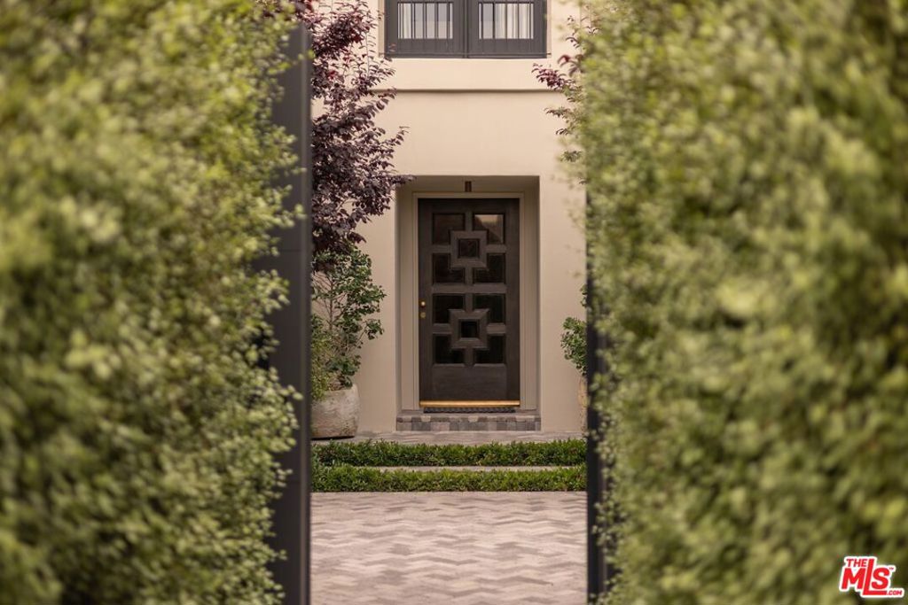 Nestled on one of Los Feliz's most coveted streets, this captivating 1930s transitional residence stands as a testament to design and craftsmanship. Renowned designers Kathleen and Tommy Clements have artfully reimagined this home, infusing it with a harmonious blend of sophistication and comfort. Timeless elegance meets modern luxury. Step through the steelworks doors and into a world of refined beauty, where warm-toned interiors and carefully curated finishes create an atmosphere of understated luxury. The main house, guest house, and pool-side loggia seamlessly intertwine, offering approximately 7,200 square feet of living space adorned with five bedrooms and seven bathrooms. The heart of the home is a spacious and inviting living area, where sunlight dances through expansive windows, casting a soft glow on the rich hardwood floors below. A cozy fireplace beckons you to unwind and relax, while thoughtful architectural details add a touch of 1930s charm. The gourmet kitchen is a chef's delight, featuring top-of-the-line appliances, custom cabinetry, and marble countertops. Outside, an elegant pool awaits, surrounded by lush landscaping and framed by high hedges creating complete privacy. A sports court provides entertainment options, while an outdoor lounge and dining area offer the perfect setting for al fresco gatherings with friends and family. The garden is adorned with Japanese maple trees, creating a tranquil retreat. Located just moments from Griffith Park, trendy boutiques, and gourmet restaurants, this exceptional residence offers the perfect blend of privacy and convenience.