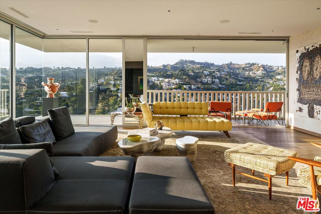 Escape to this stunning corner unit, offering breathtaking, unobstructed views from the Hollywood Hills to the Ocean. Located on the 27th floor of the iconic Sierra Towers, this residence stands out for its exceptional layout and the calming, serene feeling achieved by the vistas of the surrounding greenery. This rare gem had previously been remodeled, boasting an open floor plan where Fleetwood sliding glass doors open from the living room and both bedrooms to a generous outdoor area, perfect for lounging or simply enjoying the extraordinary views. The kitchen features hidden appliances and wood cabinetry. It also includes a washer and dryer, plus a separate staff hallway for discreet access during gatherings, ensuring flawless hosting. A powder room and wine room with a wood-framed glass door are conveniently located off the entry. A long hallway leads you past a spacious en-suite guest bedroom onto the primary suite, which is exceptionally large and designed to enjoy the tranquillity of the views. The bathroom features dual vanities and wet room with separate tub and shower areas. A water closet and sizable walk-in complete the suite. Building amenities include 24-hour valet service, a pool and spa, a gym and additional fitness room, locker rooms with saunas, and a conference room.