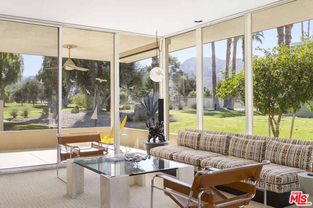 Rarely available Mid-Century William F. Cody! Experience the charm of this historically designated 1970 William F. Cody home on the beautiful Tamarisk Golf Course. This is a rare opportunity to become the next caretaker of this exceptional property, already on the Mills Act, offering a significant reduction in property taxes. Flooded with natural light, this home features a spacious open interior centered around a large atrium. The oversized step-down living room boasts stunning views of the golf course and the surrounding mountains and features a romantic fireplace and a sunken bar, perfect for entertaining guests. This Mid-Century Cody home retains many original details throughout. Beautiful tile floors, bathrooms, large pane windows, and sliders are all in excellent condition. Each room is generously sized, providing ample wall space for art. The primary suite offers breathtaking views and abundant natural light, complemented by a fantastic his-and-hers en-suite bathroom, which includes a sunken bathtub off a second private atrium. Large eat-in kitchen with Stainless Steel appliances just off the formal dining space. Additional features include two carport parking spaces, an attached golf cart garage with a bonus storage room, and a newly refinished heated pool and spa. If you are not currently a member of the Tamarisk Country Club, join up and live the desert retreat lifestyle. Don't miss your chance to experience living in a Mid-Century William Cody masterpiece!