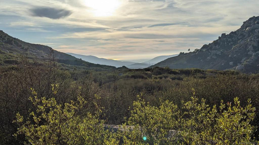 Are you ready to build a home with ocean views? Not all land deals are created equal and this property has had over $100,000 in entitlement work completed to move you years closer to your forever home. Comparable lots with lower prices can take years to get permits; What is the value of your time? One of the last great view lots left in San Diego. Perched above Honey Springs Road, you look out and see the Otay lakes and enjoy stunning, unobstructed sunsets all the way to the Pacific Ocean; all while maintaining unparalleled privacy from your own 10 acre parcel. Contact agent for a video showcasing the property! Have questions about financing and how to pay for it all? Search “one-time close construction loan” for FHA, VA and other options; VA eligible buyers should also contact CalVet about their construction loans or contact the listing agent for more information! The proposed home pad and driveway location have been submitted to the County along with plans for a 2 story, 4 bedroom and 3 bath home; or come and build your vision. These home plans are available to build or you can build your own custom home. No easements to share, no neighbors looking in on your house, and there is plenty of room to add a barn or ADU as well. SDGE electrical is ready, and in the cue for SDGE to set the post. Perc test is on file with the county, but may need to be updated. No HOA, just live and let live Jamul life. No water district, this property will need well water and septic. Contact listing agent for more information. Owner may finance. Located just minutes from the Jamul casino and 35 minutes from downtown. Parcels this size usually require living much farther out. This property is ideally situated far enough to live like a gentleman rancher, but close enough to get into town without a brutal commute. A72 zoning allows for horses, chickens and goats, perhaps a winery or wedding venue to help offset your costs or just buffer yourself from the world on 10 acres of land. The parcel has already been through the county open space process, which means the hard fights with the county have been fought for you, just come and build!