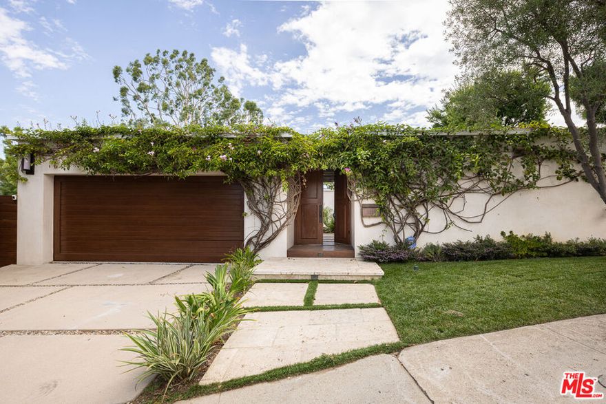 This dreamy Mid-Century single-level estate (c. 1961) in prime Studio City radiates magic from every corner and has been tastefully remodeled by the current owners. Nestled South of the Boulevard in the highly sought-after Dona streets, this exquisite 3,000+ SF property offers jaw-dropping, unobstructed panoramic views of the Hollywood Hills and surrounding canyons, all within one of the top-rated school districts in Los Angeles. Step through the vintage wooden front door and you are instantly met with a breathtaking reveal: expansive city views, an inviting yard, and a sparkling pool framed by nearly 19,000 SF of lush grounds. Before that panorama pulls you outside, a tranquil garden oasis and front courtyard with stone pavers and thoughtful landscaping greet you with serenity. Inside, abundant windows flood the interiors with warm natural light and highlight gorgeous wide-planked wood floors. Top features include recessed lighting, floor-to-ceiling windows and doors, skylights, custom built-ins, and a fully wired sound system throughout. Seamlessly blending rustic chic with modern elegance, the oversized living/dining room radiates relaxation, accented by stone walls and a dramatic central fireplace.The chef's kitchen is equally impressive, outfitted with top-of-the-line stainless steel appliances, a stone backsplash and waterfall peninsula with breakfast bar seating, a corner pantry, and built-in wine rack. Sliding glass doors connect the living and dining spaces to the outdoors, creating the ultimate indoor-outdoor flow. The backyard beckons with its sun-drenched pool, spacious deck and lounge, covered patio with outdoor kitchen, and ample green space to relax or play - all while soaking in those iconic views. Off the dining area, the luxurious primary suite offers direct hillside views, private lawn access, a spa-like bath with dual vanity, soaking tub, steam shower, and a large walk-in closet. Additional highlights include a second en suite bedroom, two more versatile bedrooms (one with custom built-in entertainment wall), a hall bath, and a detached two-car garage with laundry and bonus storage - ideal as a home gym or studio. A quintessential example of LA living, this home offers an unparalleled indoor/outdoor lifestyle in a serene yet vibrant setting. Available for lease furnished or unfurnished, it's a true Studio City showstopper.