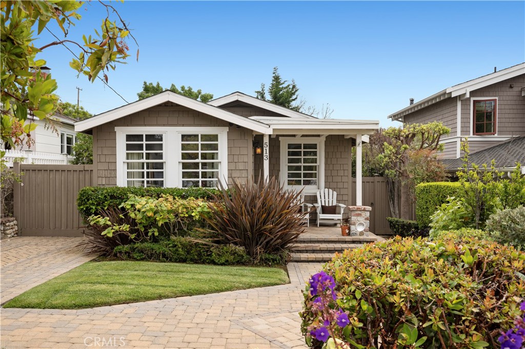 With a coveted location near sandy coves, broad beaches, famous galleries, unique restaurants and
enchanting shops, this classic 1928 shingled cottage makes it easy to leave the car at home and enjoy all
that Laguna Beach has to offer. Just moment’s from the seaside town’s popular HIP District, the single-level
home reveals a private and spacious lot of nearly 4,500 square feet. Its white picket fence is right out of a
storybook and embraces beautifully maintained grounds that display colorful gardens, pavered patios and
pathways, a long paver-finished driveway with ample parking, and a detached one-car garage. Shade trees
sway over a private backyard that complements fun times with friends, relaxing with a glass of
wine, or simply kicking back in the sunshine with your favorite book. A covered front porch and inviting Dutch
door offer a peek at the ocean and lead to a bright and open interior that features white vaulted ceilings with
exposed beams, wood flooring and crisp white-paneled walls. Open shelving and butcher-block countertops
embellish the kitchen, both bedrooms are comfortably sized, and two baths shine with updated tile and, in
one, a freestanding tub. Direct access to Oak Street Beach is only a few blocks from home, and
neighborhood parks, outstanding Laguna Beach schools, and miles and miles of scenic trails
are close by. This property captures the essence of Southern California living . . . Where every day feels like a vacation.