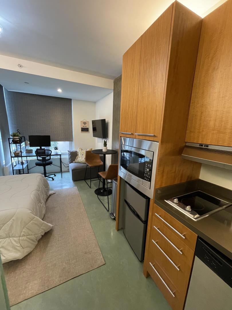 Located at the quiet rear of the building and overlooking Rizal Street, this stylish studio offers modern comfort in a prime central location. Abundant natural light fills the space through large windows, while radiant-heated concrete floors add warmth and contemporary appeal. The kitchen features stainless steel appliances, an electric cooktop with exterior venting, and a sleek modern hood. A glass door opens to a private balconyperfect for relaxing or enjoying your morning coffee. The bathroom is elegantly appointed with stone tile and a frosted glass wall and door that allow natural light to filter in while maintaining privacy. Convenient amenities include same-floor laundry, a dedicated storage room on the basement level, and first-come, first-served bike storage. Residents also enjoy access to a stunning rooftop terrace with panoramic city views, three stylish glass-walled cabanas, and two BBQ grillsideal for entertaining or unwinding. Just steps from Whole Foods, Union Square, Yerba Buena Gardens, South Park, and the Moscone Center, with easy access to public transit and the 101 South freeway right on Harrison Street, this location is truly unbeatable. Great for long-term Airbnb stays or those seeking a well-connected, low-maintenance urban retreat.