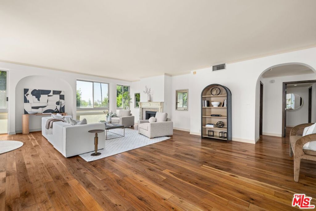 This stunning 2-bedroom, 2.5-bath condo in prime Beverly Hills offers an exceptional blend of style, comfort, and location. Perfectly situated at the prestigious corner of Burton Way and Maple Drive, this single-level residence features an open-concept design ideal for both relaxing and entertaining. The spacious layout is adorned with beautiful hardwood floors and bathed in natural light, thanks to an abundance of windows that offer views of greenery and the city. Rich with charm and chic sophistication, the home is move-in ready while also presenting the opportunity to personalize and add value. The thoughtfully designed chef's kitchen is a dream, featuring new lighting, ample cabinetry, stainless steel appliances, generous counter space, and elegant finishes that make it perfect for both culinary endeavors and social gatherings. The expansive living and dining areas offer seamless flow, flexibility, and an inviting atmosphere, ideal for everything from quiet evenings at home to lively entertaining. The primary suite is a serene retreat with generous proportions and a spa-inspired bathroom complete with a separate soaking tub and shower, offering a luxurious personal escape. The second bedroom also includes its own private bath, ensuring comfort and privacy for guests or family members. Every detail reflects quality craftsmanship and timeless style, with a bright and airy ambiance enhancing the home's livability. Additional conveniences include in-unit laundry, two side-by-side parking spaces, and access to resort-style amenities such as a pool and spa. Located just moments from Rodeo Drive, world-class dining, and high-end shopping, this is a rare opportunity to own a refined and spacious home in one of Beverly Hills' most sought-after neighborhoods.