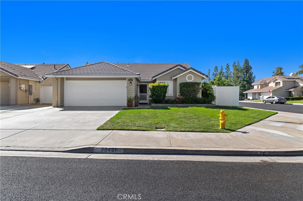 This is a cute starter home on a corner lot in the desirable Menifee Lakes community. Homeowners rarely move from this neighborhood. The home has been well-maintained and is in move-in condition. As you enter, you will notice the beautifully sculptured front door with an elegant stainglass window. The front door is upgraded with a Lockly keyless entry dead bolt that has a camera and links to your phone for more safety. The master bedroom has a large, private master bathroom and a sliding door that opens to the backyard patio with a patio cover. The backyard is artificial turf for easy maintenance. The kitchen is updated with quartz countertops and a beautiful backsplash, recessed lighting and newer cabinets. The beautiful Lake is a great place to take a walk, run, ride bikes, or just relax. The association provides a community pool, park, playground, and picnic area. La Paloma Park is across the street. The Mount San Jacinto College is within walking distance, as well as the Menifee Library. The home is also near schools, shopping, and entertainment. This community has low taxes, and you will have easy access to the 215 freeway.