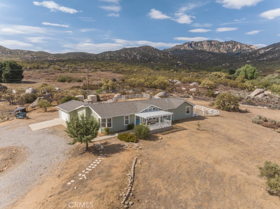 Absolutely Prime Location at the base of the Gorgeous Cahuilla Mountain in the Lake Riverside Estates Community. This home has been UPGRADED throughout!!!! Let's list the highlights first: NEW ROOF, NEW EXTERIOR AND INTERIOR PAINT, NEW LVP FLOORING AND BASEBOARDS, NEW DUAL FUEL HVAC, NEW KITCHEN AND BATH COUNTERS AND FIXTURES, PROFESSIONALLY PAINTED CABINETRY, WELL UPGRADES, NEW PERIEMTER FENCING (6FT) AND OMGOODNES THE VIEWS!!!!!!!!! You are literally the last house at the north end of the community with DIRECT TRAILS ACCESS to National Forest Trails on the Cahuilla Mountain. Hikers and Horseback Rider's Dream!!!!! LOTS of ROOM FOR HORSES!!! Spacious and Bright Floorplan with large entry living room space opening to an open floorplan with remodeled kitchen, dining room and family room!! Lots of light and windows to take in all of those gorgeous views!!!! SO PRIVATE at the end of a cul de sac and flag lot entry (gated). This home offers 4 bedrooms, 3 full bathrooms, indoor laundry and attached oversize 2 car garage. Not only is the entire property fenced, but there is also a wonderful, large fully fenced back yard area with spacious concrete patio. This home is "cleared" for fire safety and in excellent condition. There are mature trees, and the front deck offers gorgeous sweeping mountain and valley views!!! Facing east, watch the sun rise or enjoy a shaded area at the end of the day. The Lake Riverside Estates Community offers a lake, picnic areas, walking trails, pool, tot lot, equestrian arena and round pen AND a private 3600 ft lighted airstrip!! Cal Fire is located directly inside the community gates and response time is fast! Temecula is approximately 25 min down the hill for major shopping and dining. The closer town of Anza offers hardware stores, restaurants, casino, churches, schools and more! Price well and ready to just move in and start living!!!