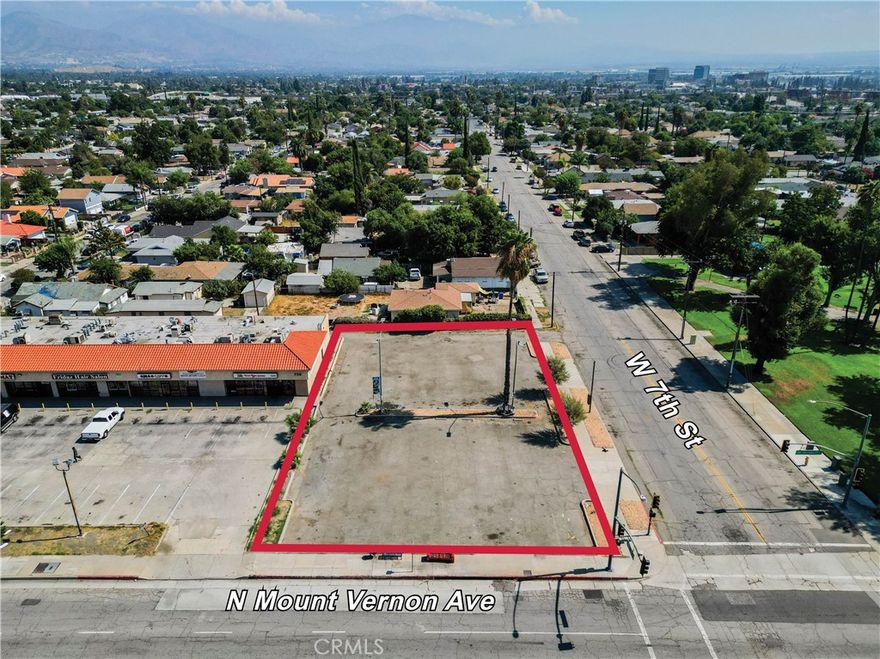Exciting opportunity to acquire a site with an existing parking lot that could potentially accomodate up to 30 vehicles. Located within an Opportunity Zone so potential tax benefits for any commercial redevelopment that is done.  Hard corner with traffic signals, so great exposure/frontage and access.  Across the street from a well maintained park. Five minutes from the 215 freeway.  Buyer to do their on due diligence on desired use for the property.