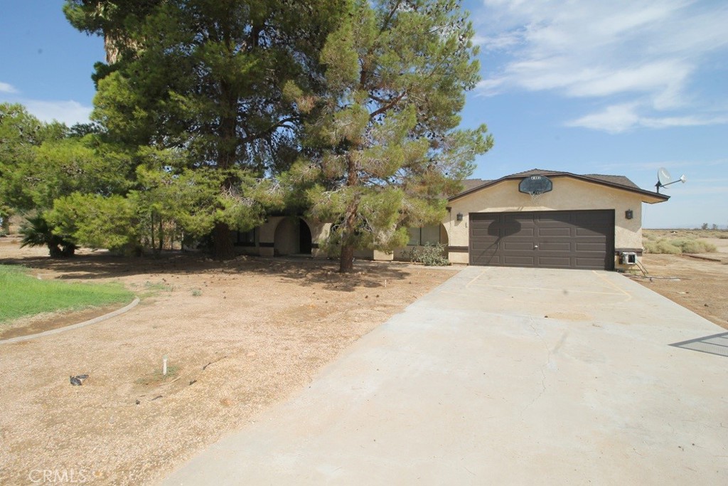 Spanish-style architecture meets the vast beauty of the California desert! Nestled on 2.6 acres, this 1,695 sq. ft. home offers the perfect blend of spacious living and serene outdoor spaces. Thoughtfully designed layout boasts expansive living areas that flow seamlessly, perfect for both entertaining guests and enjoying quiet family evenings. The heart of the home is the spacious kitchen, equipped with ample counter space. Step outside to your private fenced backyard, picture yourself sipping morning coffee on the patio, hosting summer barbecues under the open sky, or simply taking in the stunning desert sunsets that paint the horizon. With 2.6 acres at your disposal, the possibilities are endless—create a lush garden, set up a tranquil retreat, or indulge in your hobbies with space to spare. Located in the peaceful community of Newberry Springs, this home provides the perfect escape from the hustle and bustle of city life.