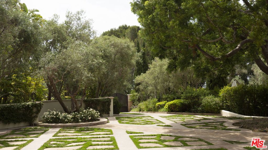 Set in a coveted Malibu enclave consisting of four homes on a private, double-gated street above Escondido Beach and Paradise Cove. This legendary estate, once the primary residence of Rock & Roll Hall of Famer Tom Petty, spans 2.6 acres of lush, park-like grounds and offers an exceptionally rare blend of privacy and artistry. Skylights stream light into each thoughtfully designed space, illuminating the home's rich character. Wood-beamed ceilings, vintage chandeliers, exquisite wrought iron detailing, and five stunning fireplaces throughout, including one in the formal dining room with seating for 16 - ideal for unforgettable gatherings. Take sanctuary in the primary retreat featuring sitting area with romantic fireplace, exclusive patio with fountain, and luxurious bath highlighted by soaking tub and steam shower with Moroccan tiles. The enormous walk-in closet with island is worthy of rock royalty. Bonus room with skylights, fountain and dry sauna offers flexible space for gym/yoga/massage room. All bedrooms offer direct access to the outdoor gardens and trellised patios complete with built-in BBQ, in-ground fire pit, manicured lawns, and a glistening pool with spa making it an entertainer's dream. The estate is surrounded by meticulously curated grounds where bougainvillea, white roses, jasmine, and wildflowers flourish. Tom's personal music studio, transformed from a 2-bedroom guest house and garage, remains fully pre-wired-ready for someone else's "runnin' down a dream." An additional 1-bedroom studio is nestled next to a tranquil side yard with pond. Motor court with parking for 15+ cars, solar panels for sustainable living, staff quarters, generator and a night-lit sports court ready for basketball /pickleball found just steps from the driveway. Surrounded by cascading waterfalls, koi ponds, fruit trees, and fountains, this estate has been referred to as a "Mini Huntington Gardens." For nearly 30 years, it served as a refuge of inspiration, peace, and creativity for one of music's greatest legends. This is more than a home it's a piece of rock history. A haven where the next chapter is ready to be written!