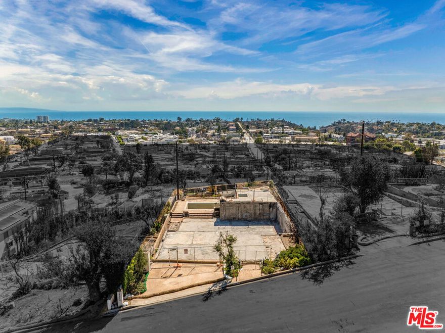 Perched above the Alphabet Streets, this 7,140 SF parcel presents a premier opportunity to create a custom coastal home with unobstructed views of the Pacific Ocean and the Santa Monica coastline. Once home to a striking 6,342-square-foot Spanish Revival residence designed by Charles A. Sampson and crafted by Artisan Pacific Homes in 2010, the site offered seven bedrooms, eight bathrooms, and three levels of refined living space complemented by a resort-style outdoor retreat featuring a pool, spa, firepit, and outdoor kitchen. Following the recent wildfire, the property now offers a pristine canvas -- yet with the unique advantage of plans and reports already in place. Included in the sale are the original 2009 architectural plans, a 2025 asbestos soils report, a 2025 core testing report, and the 2025 final fire debris removal permit -- streamlining the rebuilding process for its next visionary owner. Elevated and private, the parcel is ideally positioned to capture sweeping vistas that extend along the Santa Monica coastline to the Palos Verdes Peninsula and across the Pacific to Catalina Island. Nestled between Rimmer Avenue and Monument Street, this exceptional site offers tranquility and seclusion while being mere moments from the vibrant Palisades Village and conveniently connected to the Westside via Sunset Boulevard, Temescal Canyon Road, and Pacific Coast Highway. Seize this rare opportunity to secure a head start in crafting your ultimate dream home while contributing to the renewal and resilience of this cherished community.
