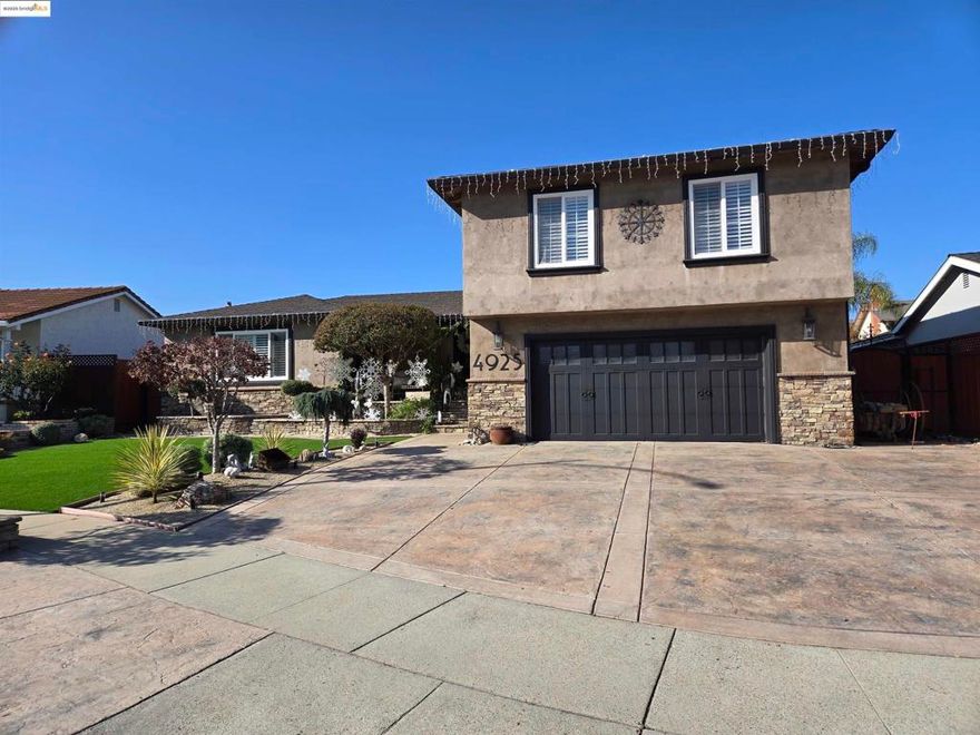 ***OPEN HOUSE SAT. 12/20 FROM 12-3***  Beautifully upgraded home designed for exceptional indoor/outdoor living. Striking custom iron entry doors make an impressive first statement, setting the tone for the quality throughout. Inside, enjoy granite countertops, double oven, dishwasher, gas stove, two new gas fireplaces, new tile flooring, hardwood floors in the office, and custom built-in cabinets surrounding the TV. A spacious man cave/game room with stone accents opens to a fully equipped outdoor kitchen. The backyard is an entertainer’s retreat with new landscaping, low-voltage lighting, a decorative water feature, hot tub, and rod iron gates. Exterior upgrades include a new roof, updated garage door, and an upgraded 8-ft fence for added privacy. Move-in ready with thoughtful details throughout.