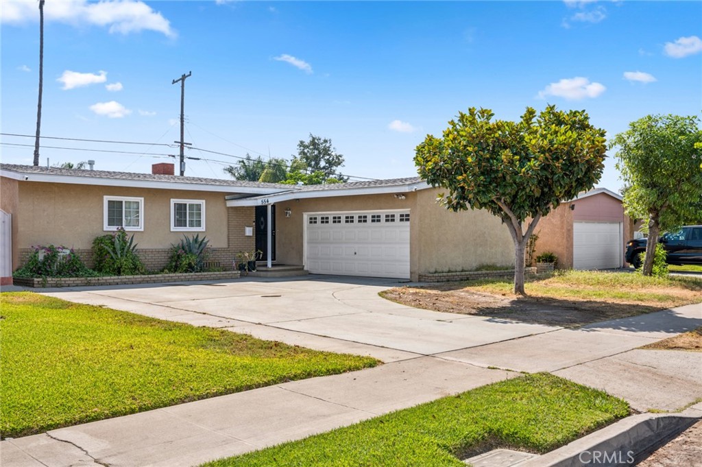 Welcome to this beautiful, ranch-style, single-story home nestled in the heart of North Anaheim. Built in 1954, this home features 1,390 sq. ft. of living space perfect on a generous 6,342 sq. ft. lot. This property is the perfect chance to reimagine a fresh space to your liking. With ample natural light and a versatile layout, this single story home is primed for updating and remodeling to suit your personal style. Immediately upon entry, you are greeted by timeless charm and simplicity, with a comfortable living room equipped with fireplace, which leads directly into an offset dining area. Much of the home features the original wood floors adding to the property’s unique charm. The kitchen offers granite countertops, wood cabinets with plenty of storage, appliances and an extra area perfect for more storage or a small desk. This home features 4 bedrooms with ceiling fans and closet space in each. The primary bedroom has en suite bathroom with walk in shower, with an additional full bathroom in the hall. Each full bathroom in the property presents the potential for modern upgrades, making it easy to personalize. Entertaining is effortless in the expansive backyard, complete with a covered patio and custom-built BBQ area—perfect for welcoming summer gatherings. A two-car attached garage with laundry and additional storage, and driveway offer convenient parking—plus room for a boat or additional trailer. This property is centrally located within Anaheim, offering access to local parks, schools, shopping, major freeways, and is within minutes of Disneyland, Angel Stadium, Honda Center, the Anaheim Packing District and more! This property not only provides an excellent foundation, but is the perfect opportunity for anyone to turn a house into a home.