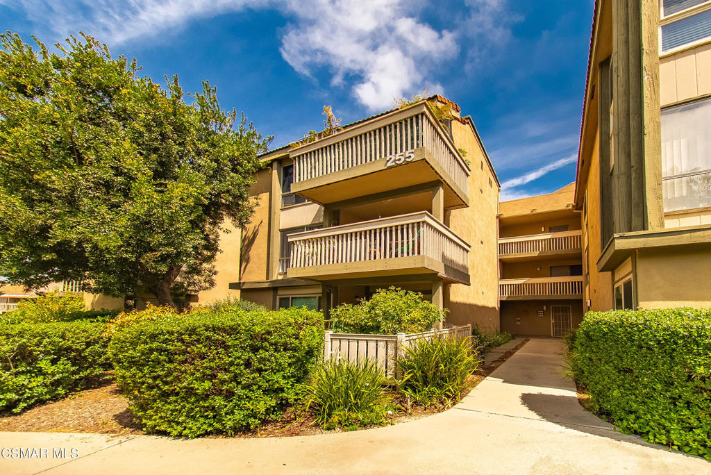 Meticulously kept, low maintenance corner unit in Oak Knoll Villas is filled with extra windows to show case the natural light and outdoor greenery. This 2 bedroom, 2 bath open floorplan offers a large covered patio space right off the living room and second bedroom to take in the breeze and unwind. Inviting living room offers an atmosphere to entertain and relax. Remolded white kitchen features stainless steel appliances, lots of storage and refrigerator. This unit has been recently painted throughout with recently installed desirable light wood-like flooring, upgraded baseboards, and finished with complimentary light fixtures. Primary bedroom boast ample closet space, attached updated full bathroom, and large windows to provide natural light. Hall bath has been upgraded with a sleek black and white design and offers large walk in shower, vanity and storage. Second bedroom offers large windows and access to exterior patio and offers the current owner a peaceful workout room and office space. This unit is located on the second floor and easily accessible by elevator. The laundry room is conveniently available within the building as well. The designated carport space is 265 and storage is conveniently located close to the unit. This active senior community offers a wide variety of amenities to include: onsite management, a pool, a spa, walking paths, clubhouse, billiards table, library, fitness center, outdoor BBQ's, a shuffle board court, and a community laundry facility, too! Enjoy community organized monthly social activities. Plenty of guest parking. The area surrounding the unit is lush with mature landscape. HOA dues cover common area maintenance, exterior earthquake insurance, trash, basic cable and WIFI. Primary owner must be at least 55 years old, secondary resident may be 45 or older. Community is located close to weekly farmers market, Botanical gardens, scenic hiking/biking trails, shopping, dining, theaters and parks! Come take a look! A great opportunity for resort living in a beautiful community!