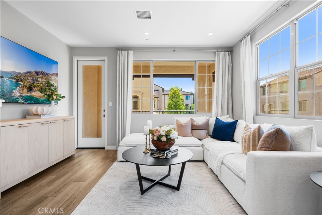 Welcome to this stunning former model home in the highly desirable community of Cypress Village. Beautifully designed, this tri-level condo, with paid-off solar, enjoys a desirable corner location next to the park, with serene park views from the kitchen and dining room. As a formal model home, it showcases designer upgrades throughout, from elegant flooring and custom finishes to a thoughtfully curated color palette that enhances its modern charm. The bright and airy main living space features an open-concept layout, highlighted by a gourmet kitchen with quartz countertops, sleek cabinetry, and stainless steel appliances. The adjoining dining and living areas create the perfect setting for both entertaining and everyday living. Upstairs, the spacious primary suite includes a spa-like bathroom with dual sinks and a generous walk-in closet, while the secondary bedroom is ideal for family, guests, or a home office. Located just steps away from Cypress Village’s resort-style amenities—sparkling pools, parks, playgrounds, and scenic trails—this home also offers unmatched convenience with top-rated Irvine schools, shopping, dining, and freeway access all nearby. Combining modern style, comfort, and prime location, this beautiful home presents a rare opportunity to own a move-in-ready home in one of Irvine’s most sought-after communities.