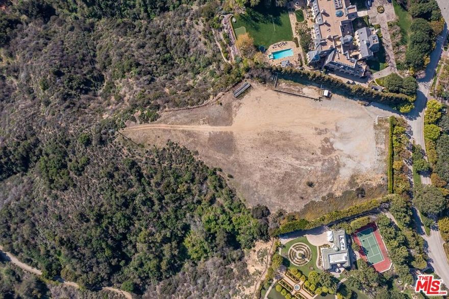 Rare opportunity to create your dream home on the crown jewel lot of North Beverly Park.  One of the last undeveloped parcels in North Beverly Park on the market for the first time in over 20 years.  Featuring 2.86 FLAT ACRES, total privacy, and over 450 feet of frontage along the rim with sweeping canyon and city views.  A blank canvass that is a once in a lifetime opportunity to live in what many consider to be the most exclusive guard gated community in the country.